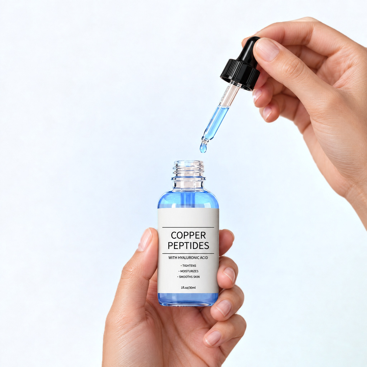 Hands holding the copper peptide serum with the dropper, on a white and soft blue background